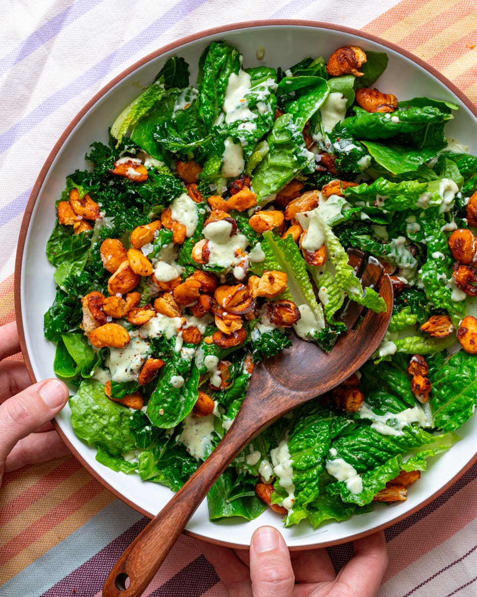 assemble the kale and butter bean caesar salad